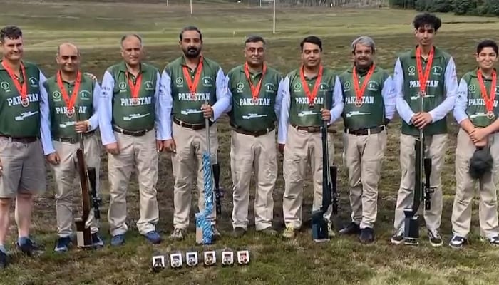 Pakistani shooters pose for a group photo with their rifles and medals won at Long-Range Shooting Championship in UK. — Reporter/File