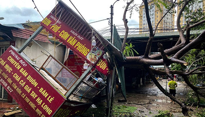 A man walks past a devastated area following the impact of Typhoon Yagi, in Hanoi, Vietnam, September 8, 2024. — Reuters