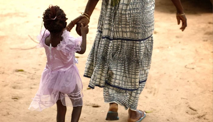 A representational image showing a mother and daughter walk home after attending a community meeting about eradicating female genital mutilation.  — Reuters/File