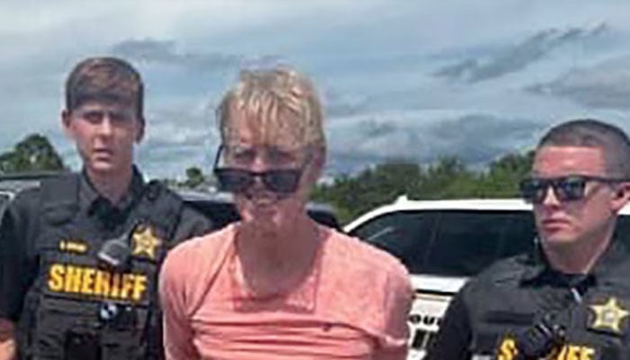 Ryan W Routh, suspected of attempting to assassinate Republican presidential nominee and former US President Donald Trump at his West Palm Beach golf course, stands handcuffed between two Martin County Sheriffs office deputies after his arrest during a traffic stop near Palm City, Florida, US, September 15, 2024. — Reuters