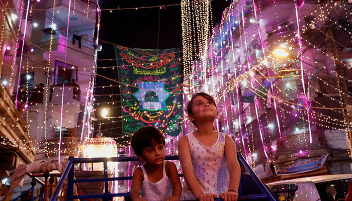 Siblings ride on a swing as they visit an illuminated street ahead of Eid-e-Milad-ul-Nabi, the birth anniversary of Prophet Mohammad, in Karachi, Pakistan, September 15, 2024. — Reuters