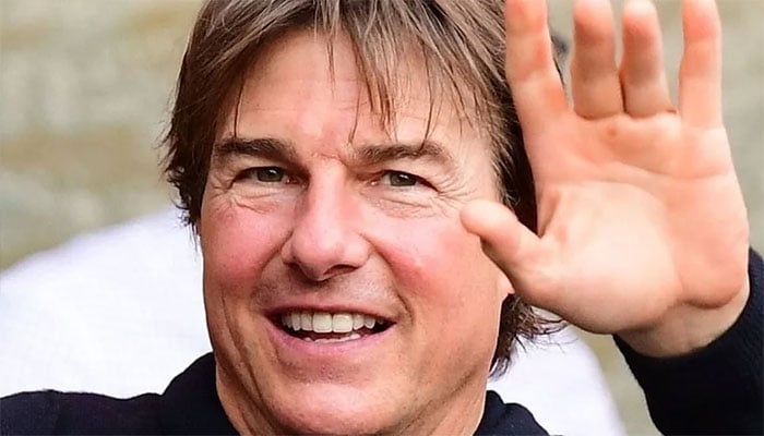 Tom Cruise takes to the skies, arrives at Battersea.