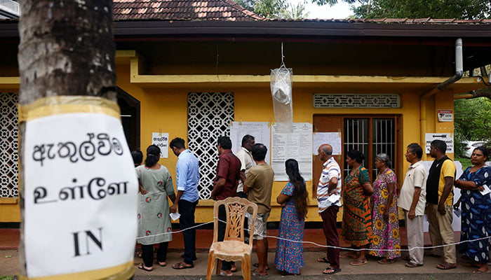 People stand in a queue to vote at a polling station during the presidential election in Colombo, Sri Lanka, September 21, 2024. — Reuters