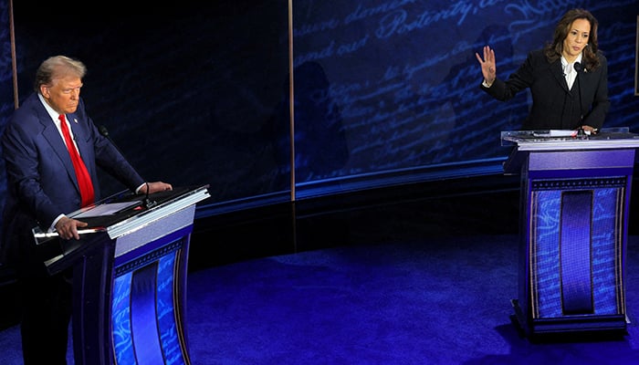 Former US president and Republican presidential candidate Donald Trump (L) listens as Democratic presidential nominee and US Vice President Kamala Harris speaks during a presidential debate hosted by ABC in Philadelphia, Pennsylvania, US on September 10, 2024. — Reuters