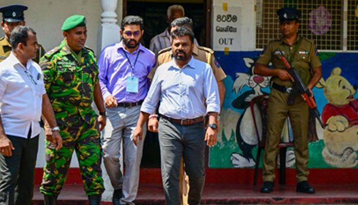 National People’s Power (NPP) party’s presidential candidate Anura Kumara Dissanayaka (second from right) leaves a polling station after casting his ballot during voting in Sri Lanka’s presidential election in Colombo on September 21, 2024. — AFP