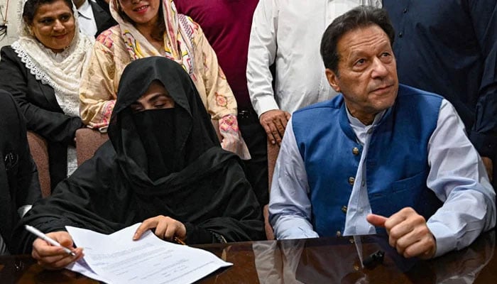 Pakistan Tehreek-e-Insaf founder Imran Khan and his spouse Bushra Bibi seen in this image. — AFP/File