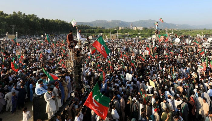 PTI supporters wave party flags during a rally in Islamabad on Sept 8, 2024. — Reuters