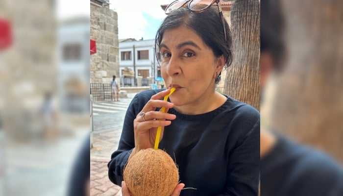 UK politician Sayeeda Warsi poses for a photo while drinking coconut water. — X/ @SayeedaWarsi