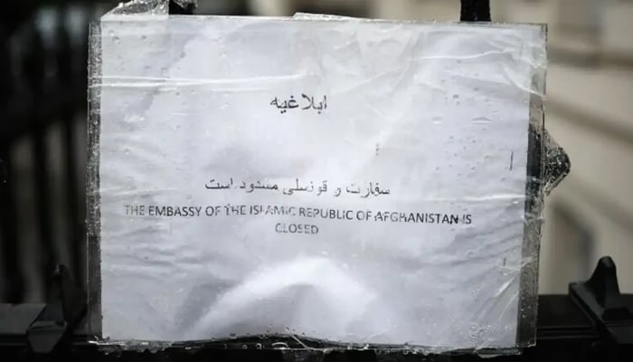 A photograph shows a notice stating “The Embassy of the Islamic State of Afghanistan is closed” left on the railings outside the Afghanistan Embassy in west London on September 27, 2024. — AFP