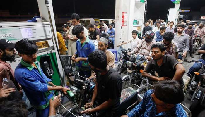 People wait their turn to get fuel at a petrol station, in Karachi, Pakistan June 2, 2022. — Reuters