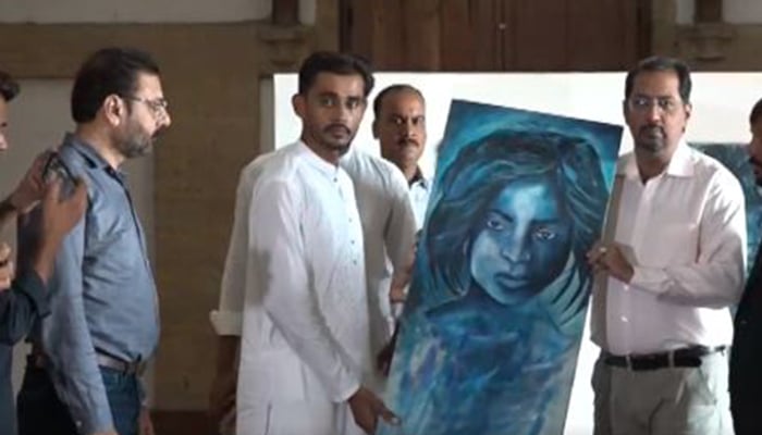 Artist Saifi Soomro pictured during the handover ceremony of his lost paintings at Frere Hall, Saddar, Karachi, Pakistan on September 30, 2024. — Screengrab via Geo News