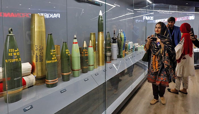 Visitors inspect the armour ammunition display kept in a showcase during the International Defence Exhibition and Seminar IDEAS 2022 in Karachi on November 16, 2022. — Reuters