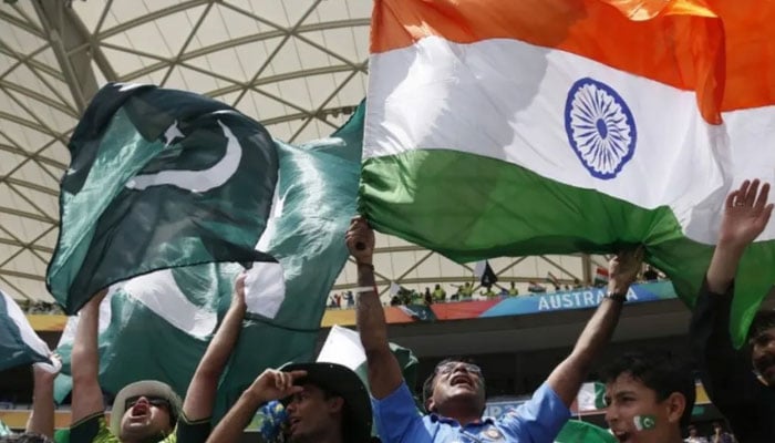 A representational image showing Pakistani and Indian cricket fans holding their national flags during a match. — Reuters/File