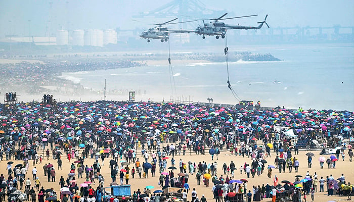 Indian Air Force (IAF) helicopters perform during an airshow ahead of the Indian Air Force day celebrations at Marina beach in Chennai on October 6, 2024. — AFP