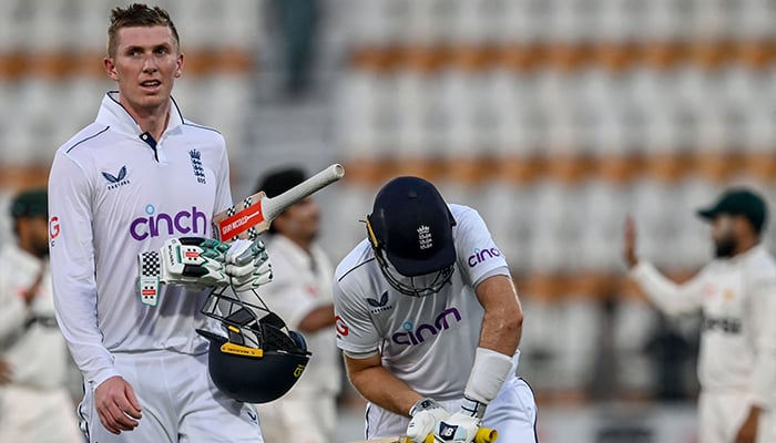 Englands Zak Crawley (L) and Joe Root (C) walk back to the pavilion at the end of the second day of the first Test cricket match between Pakistan and England at the Multan Cricket Stadium in Multan on October 8, 2024. — AFP