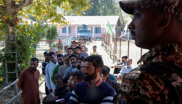 People queue to vote at a polling station, during the third and final phase of assembly elections, in Handwara in Indian Illegally Occupied Jammu and Kashmir on October 1, 2024. — Reuters