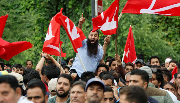 Supporters of the Jammu and Kashmir National Conference party shout slogans as they celebrate outside the vote counting centre on the day of the assembly election results, in Srinagar, October 08, 2024. —Reuters