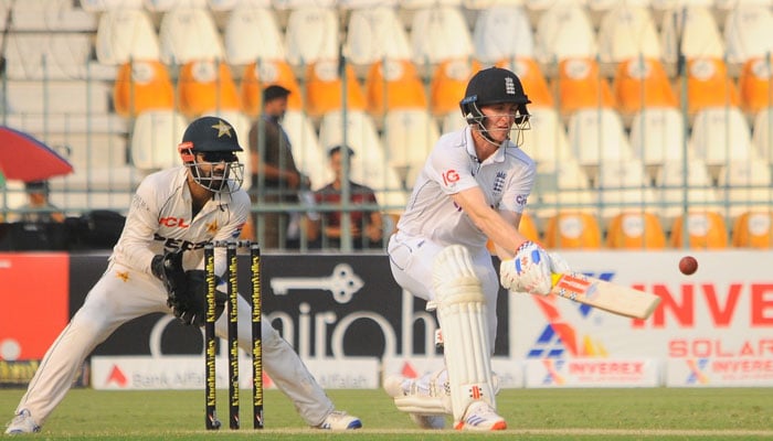 Pakistans wicketkeeper Mohammad Rizwan keeps the wicket (L) while Englands Harry Brook plays a shot during the first Test in Multan on October 9, 2024. — PCB