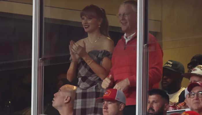 Taylor wearing Vivienne Westwood matching skirt-and-shirt set with a coordinating heart-shaped bag