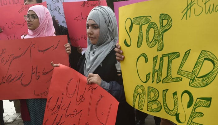 Pakistani demonstrators carry placards during a protest against the rape and murder of a child in Lahore on January 11, 2018. — AFP