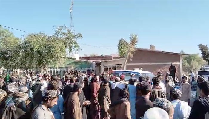 People gathered outside a medical facility where bodies of the deceased miners were kept, seen in this still taken from a video. — Reporter