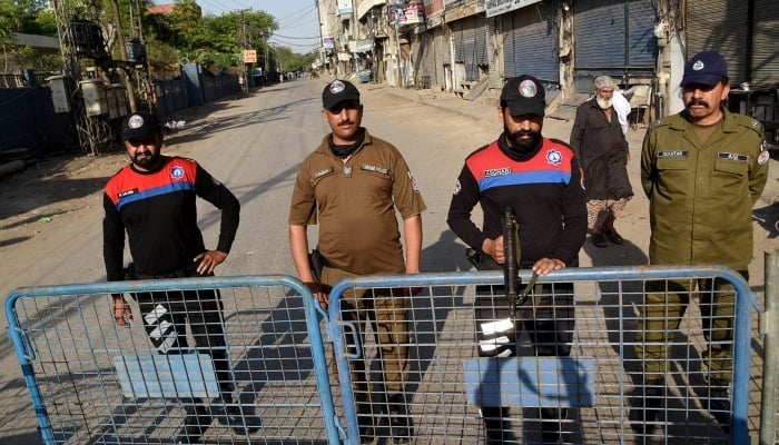 Police officials stand alert in Lahore on April 21, 2024. —APP