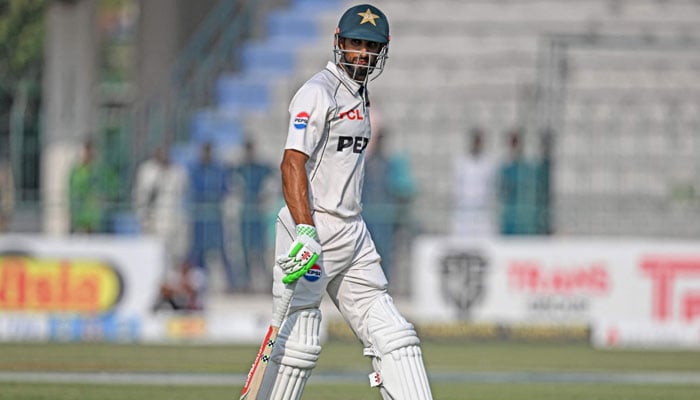 Pakistans captain Shan Masood walks back to the pavilion after his dismissal during the fourth day of the first Test cricket match between Pakistan and England at the Multan Cricket Stadium in Multan on October 10, 2024. — AFP