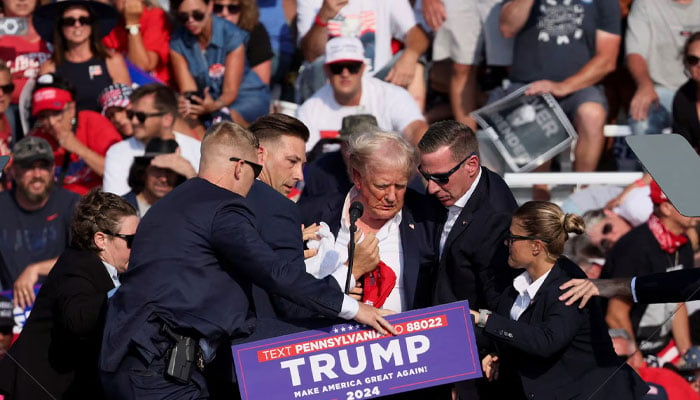 Republican presidential candidate and former US President Donald Trump is assisted by US Secret Service personnel after gunfire rang out during a campaign rally at the Butler Farm Show in Butler, Pennsylvania, US, July 13, 2024 — Reuters.