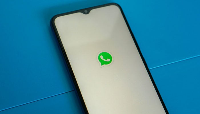 A representational picture showing a phone with the WhatsApp logo displayed on its screen. — Unsplash