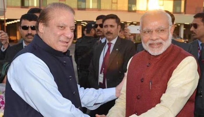 The-then Prime Minister Nawaz Sharif (Left) shakes hands with Indian Prime Minister Narendra Modi (R) shakes hands in Lahore on December 25, 2015. — AFP