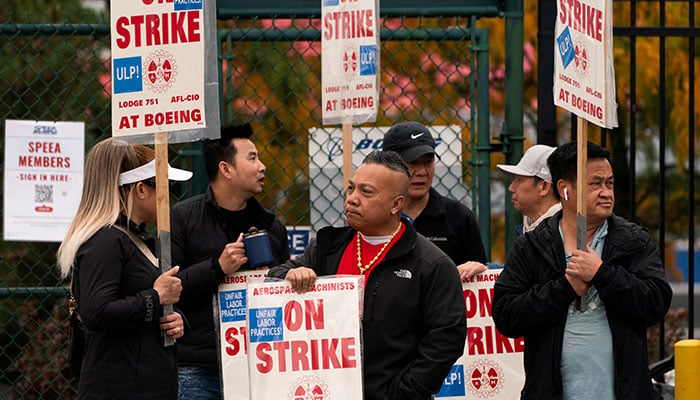 Boeing factory workers and supporters gather on a picket line near the entrance to a Boeing production plant in Renton, Washington, United States, October 11, 2024. — Reuters