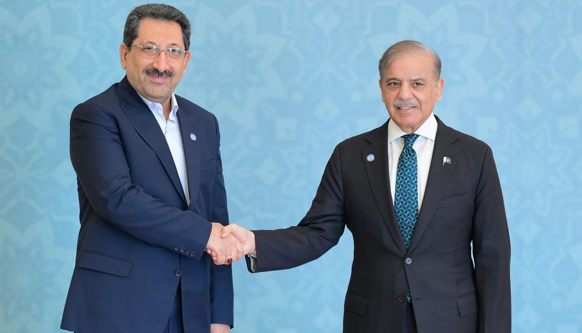 PM Shehbaz Sharif shakes hands with Irans Minister of Industry Mohammed Atabak at the Jinnah Convention Centre for the SCO summit in Islamabad on October 16, 2024. — PID