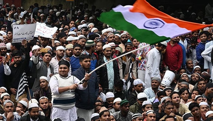 A Muslim man waives the Indian flag during a demonstration. — AFP/File