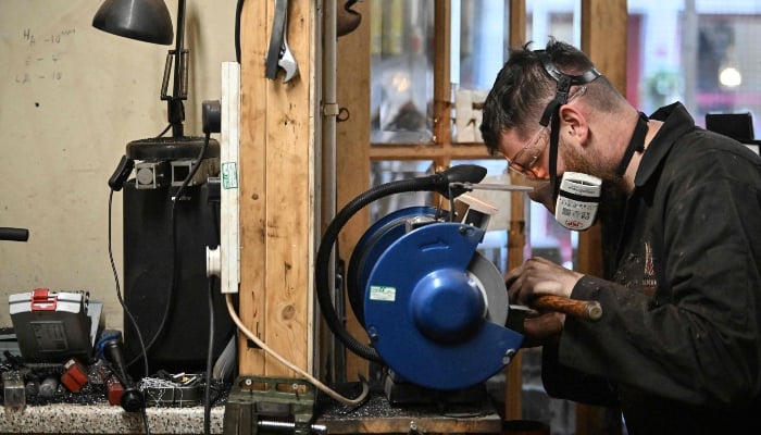 Ruari Black makes a bagpipe chanter in the workshop of Kilberry Bagpipes in Edinburgh, on October 7, 2024. — AFP