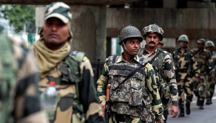 A representational image showing Indian security forces personnel patrol a deserted street. — Reuters/File