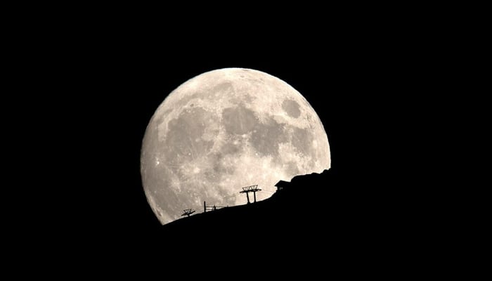 A ski lift at the Kalavrita ski centre on Mount Helmos is silhouetted as the moon rises near the town of Kalavrita, Greece, August 14, 2019. — Reuters