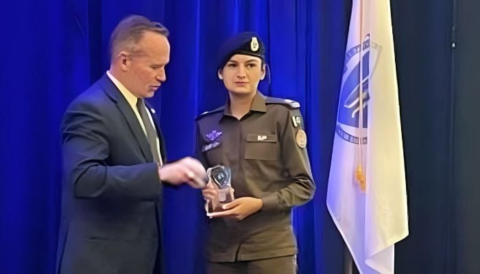 Rawalpindi Chief Traffic Officer SP Beenish Fatima (right) receives the award from the IACP president. — X/@OfficialDPRPP