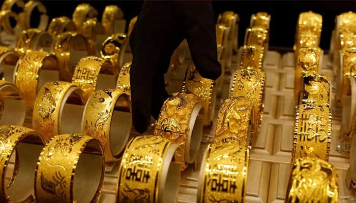 An employee places ingots of 99.99 percent pure gold in a workroom at the Novosibirsk precious metals refining and manufacturing plant in the Siberian city of Novosibirsk, Russia, September 15, 2023. — Reuters