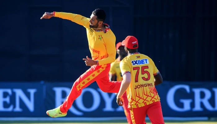 Zimbabwes skipper Sikandar Raza (L) celebrates after taking a wicket. — Zimbabwe Cricket/File