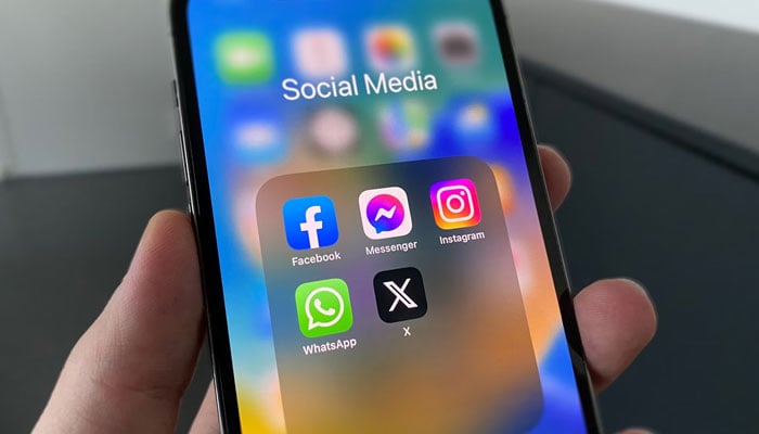 A representational image showing the icons of different social media platforms displayed on a phone screen. — Unsplash