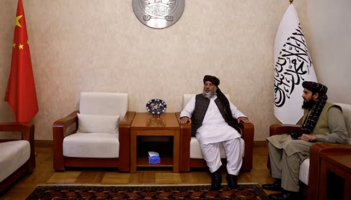 Talibans acting commerce minister Haji Nooruddin Azizi sits next to flags of Afghanistan and China, during an interview, at the Embassy of Afghanistan in Beijing, China, on October 19, 2023. — Reuters