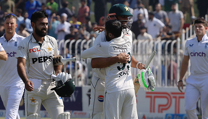 Pakistans skipper Shan Masood embraces Saud Shakeel after winning the third and final Test against England at the Rawalpindi Cricket Stadium on October 26, 2024. — Reuters