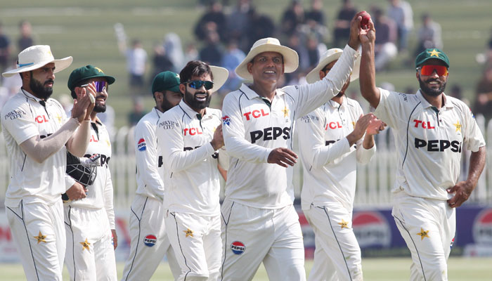 Pakistans Noman Ali and Sajid Khan pose with the match ball during the third and final Test against England at the Rawalpindi Cricket Stadium on October 26, 2024. — PCB