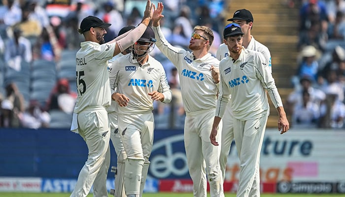 New Zealands Glenn Phillips (C) celebrates with teammates after taking the wicket of Indias Yashasvi Jaiswal during the second day of the second Test at the Maharashtra Cricket Association Stadium in Pune on October 25, 2024. — AFP