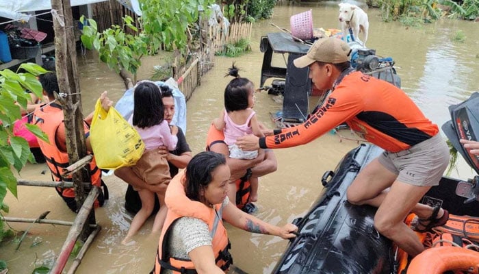 Philippine Coast Guard personnel rescue residents after flood waters rose from heavy rains brought by Tropical Storm Trami, in Bicol, Philippines on October 23, 2024. — Reuters