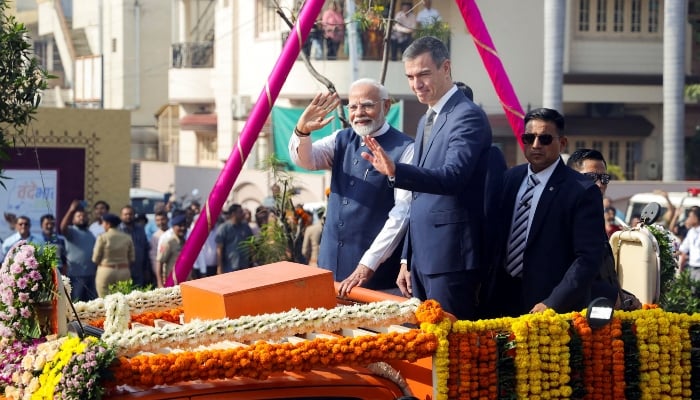 Indian Prime Minister Narendra Modi and Spanish Prime Minister Pedro Sanchez wave to their supporters during a roadshow in Vadodara, India, on October 28, 2024. —Reuters