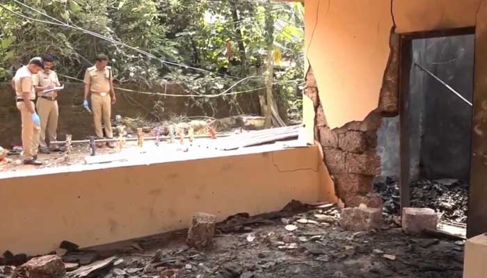 Police officers inspecting the site of the explosion in a firework storage facility near Hindu temple at Nileshwaram, Kerala can be seen in this still taken from a video. — X/@PTI_News