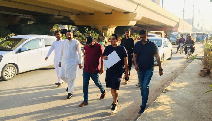 This undated photo shows bureaucrat Hazim Bangwar (second from right) visits a project in Karachi. — Facebook/Hazim Bangwar