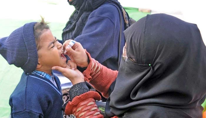 A lady health worker administers polio drops to students at school during a polio eradication campaign in Hyderabad on January 8, 2024. — Online