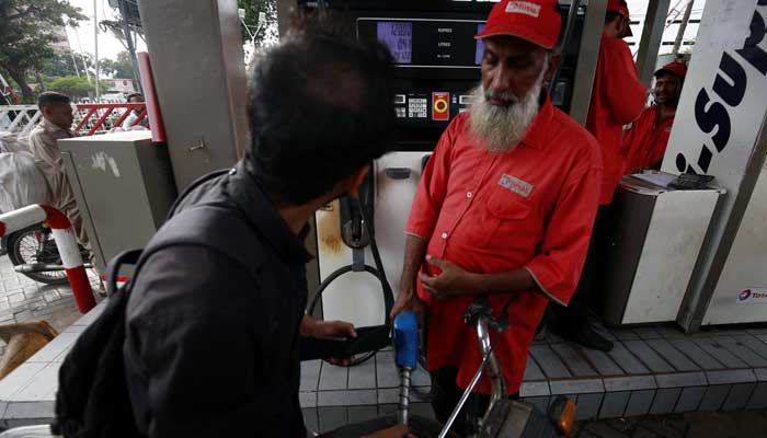 Fuel station worker filling petrol in vehicle, at Fuel Station in Karachi on Tuesday, April 16, 2024. — PPI